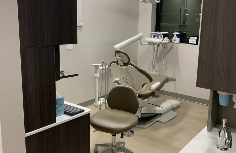 A treatment room at Dean Cosmetic Dentistry with its dental chair and arched window.