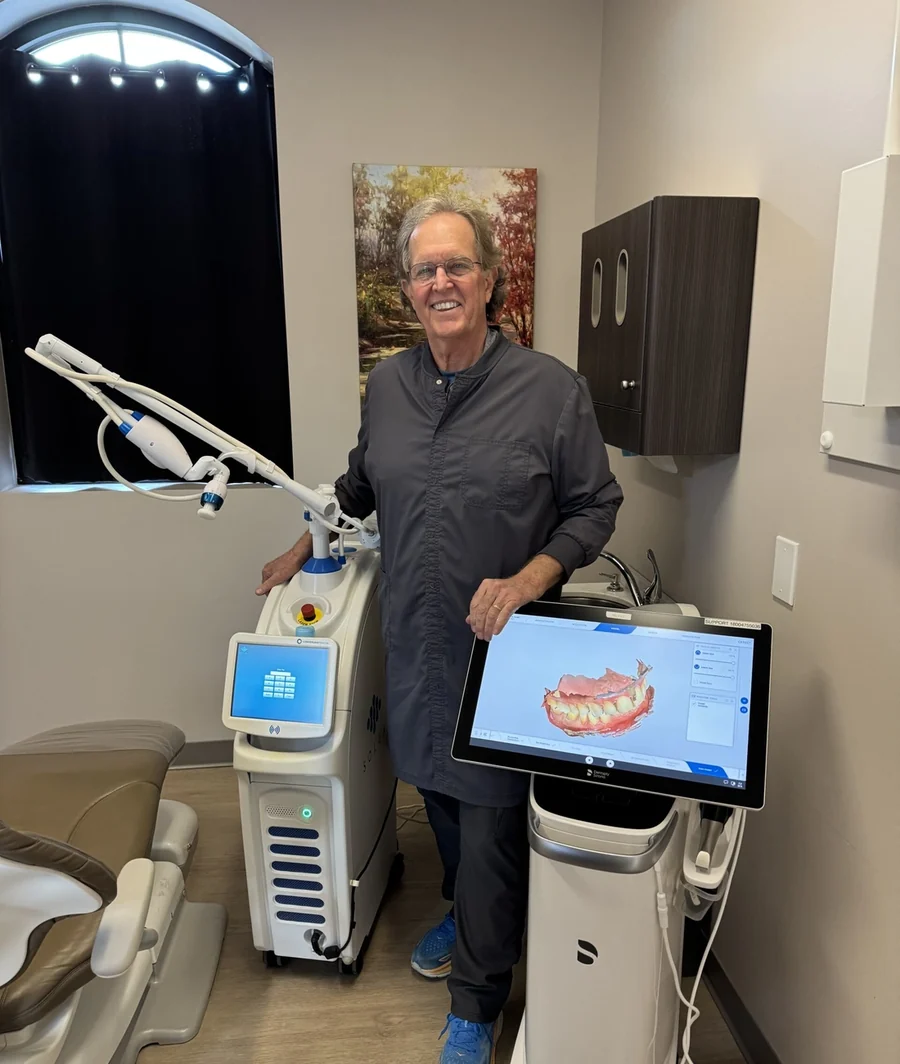 Dr. Donnie Dean in a treatment room between the Solea laser and the Primescan scanner.